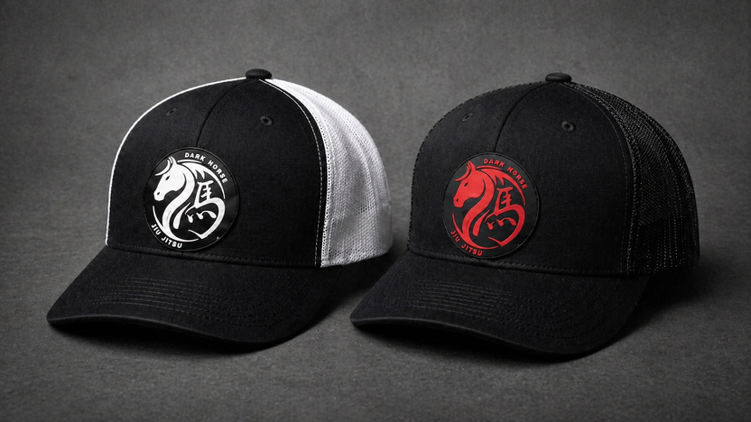 Two branded company hats with embroidered logos